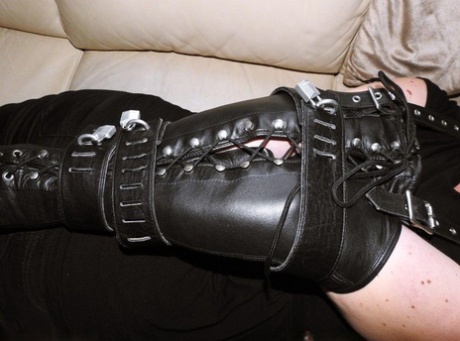 Pale redhead finds herself restrained on a couch in leather arm binders 62561359