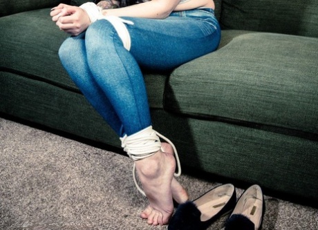 Dark-haired girl sports a big ball gag while bound at the wrists and ankles 98661098