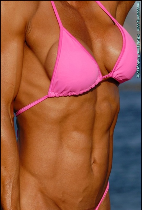 Asian bodybuilder Jennifer Dejoya flexes on a beach in a pink bikini 96390157