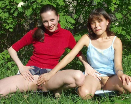 Lesbian amateurs flash their tits and asses in a park before licking pussies 75312587
