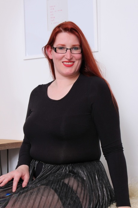 Older redhead on the plump side bares her saggy tits before toying her beaver 78936424