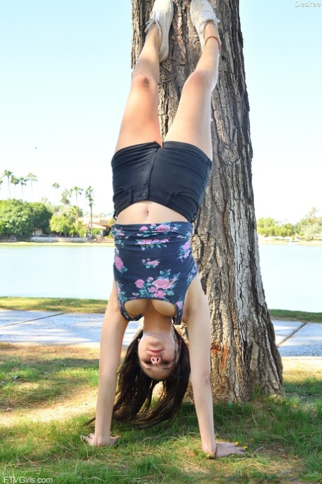 Flexible amateur Desiree goes for a jog in the park in her bra and shorts 14357176