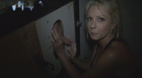 Blonde woman sucks the cum from a penis while visiting a gloryhole 46966823