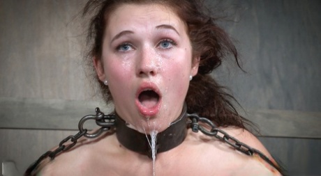 Submissive female Stephie Staar drips spit and jizz off her chin in a dungeon 56066090