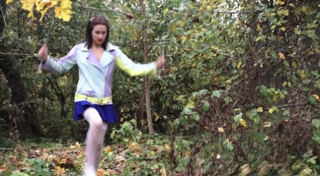 Clothed girl Kristina hitches up her skirt for a pee near a ruined building 86252229
