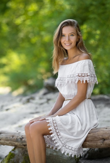 Pretty teen Clover removes an off shoulder dress to pose nude on driftwood 47213885