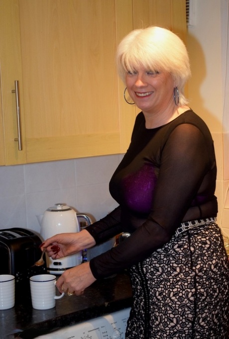 Mature platinum blonde prepares a stir fry while fully clothed 18654417