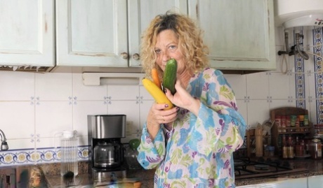 Mature woman with wavy blonde hair Anne Swinger masturbates with a cucumber 67243472