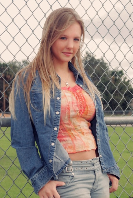 Cute blonde Dawson Miller uncovers her big natural tits at a ball diamond