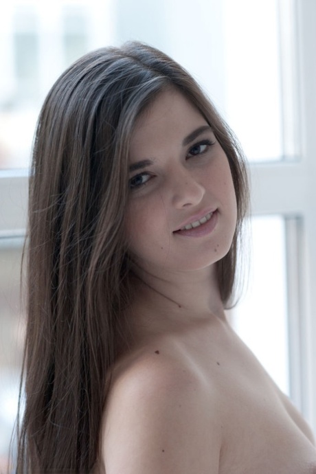 Beautiful brunette teen Natalya A gets completely naked next to a window 23224088