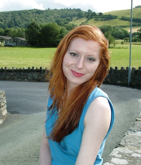 Clothed redhead Miranda is revealing her sexy ass in her backyard 79929618